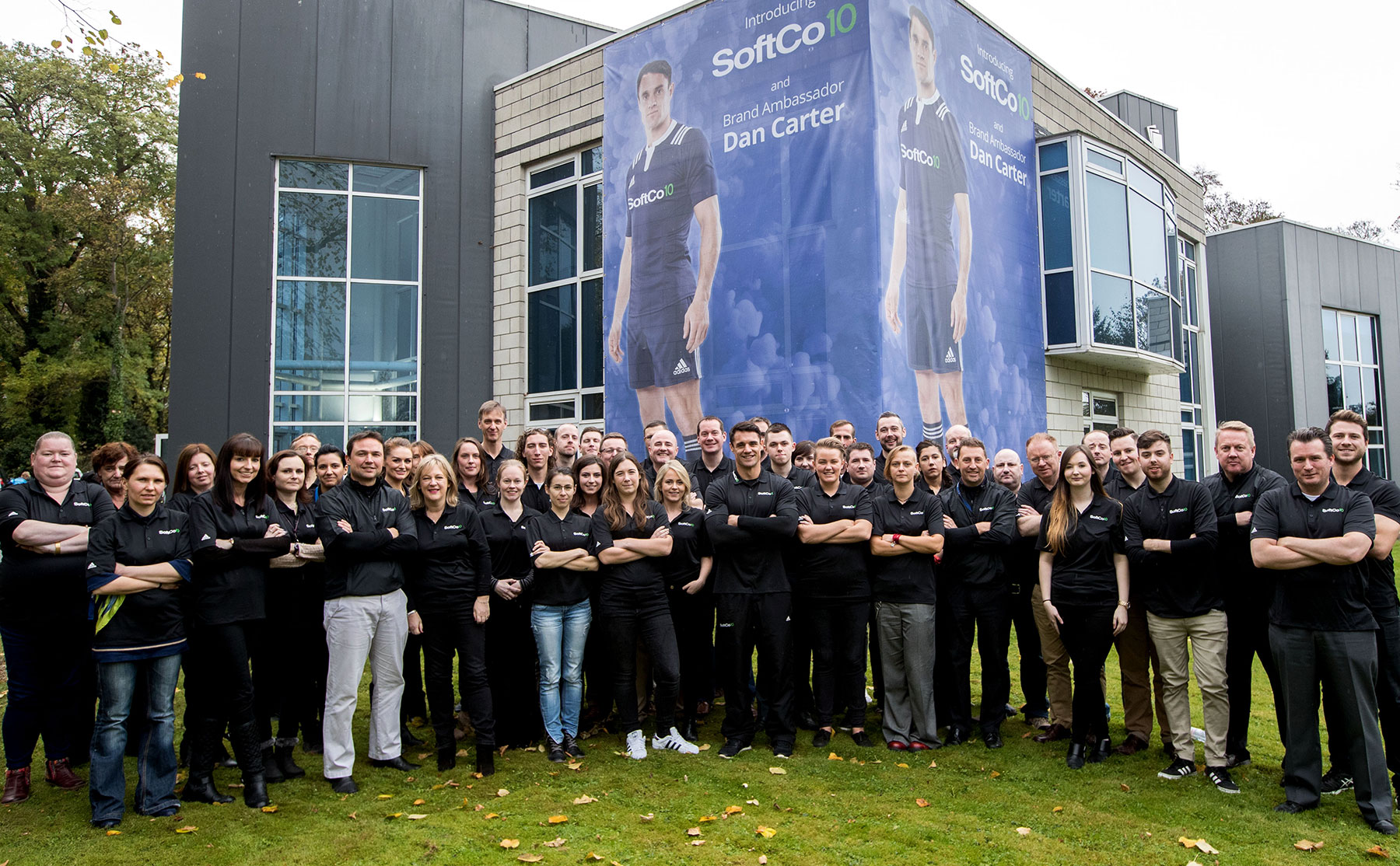 SoftCo team in front of building